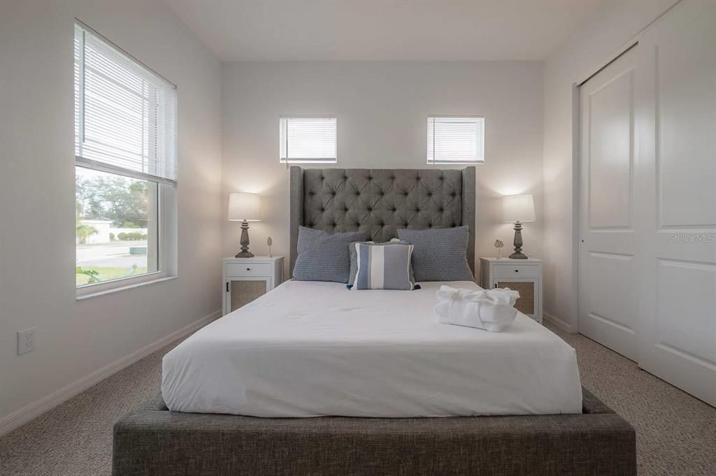 Bedroom 3 with queen-size bed and four windows to allow lots of natural light.