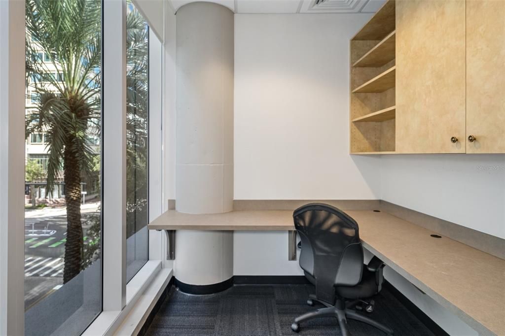 The private offices have custom cabinetry and desks.