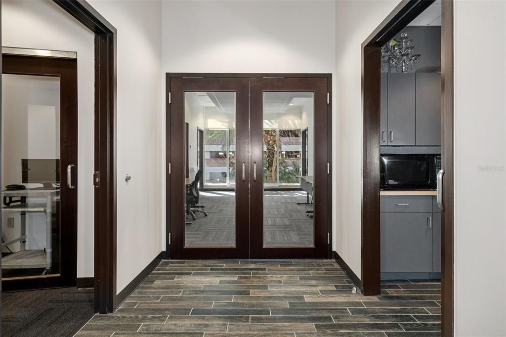 Double door entry to conference room and private offices.