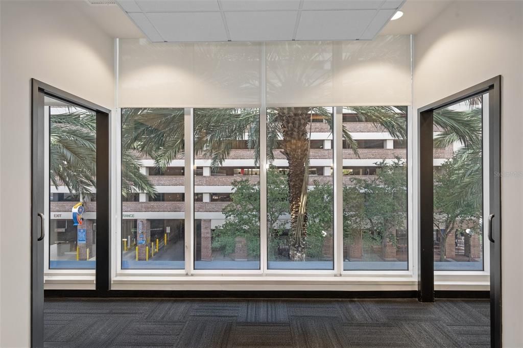 Floor to ceiling windows with window treatment.