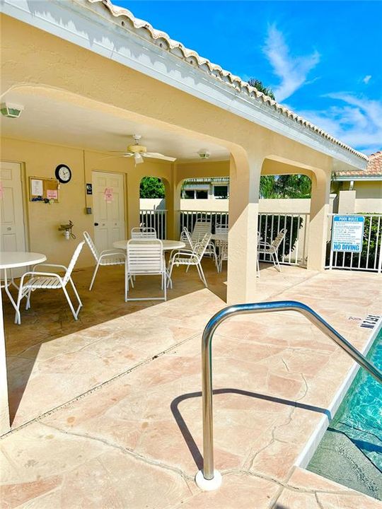 Pool with bathrooms and tables across the street