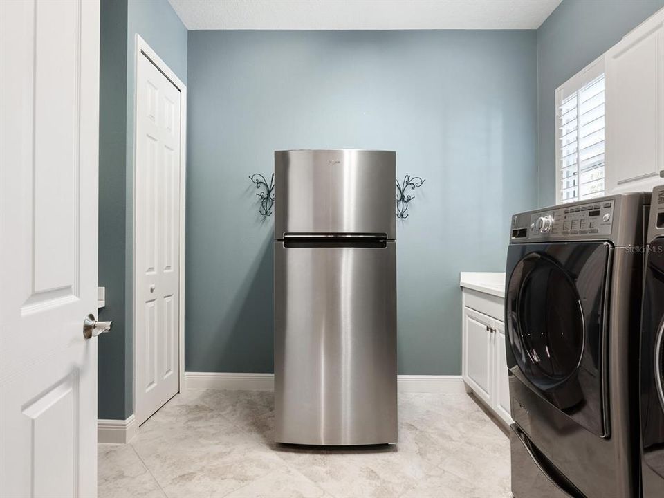 Laundry room built-in desk, Double Closets with ample storage space, GE washer/dryer, sink, and can fit a full-size refrigerator