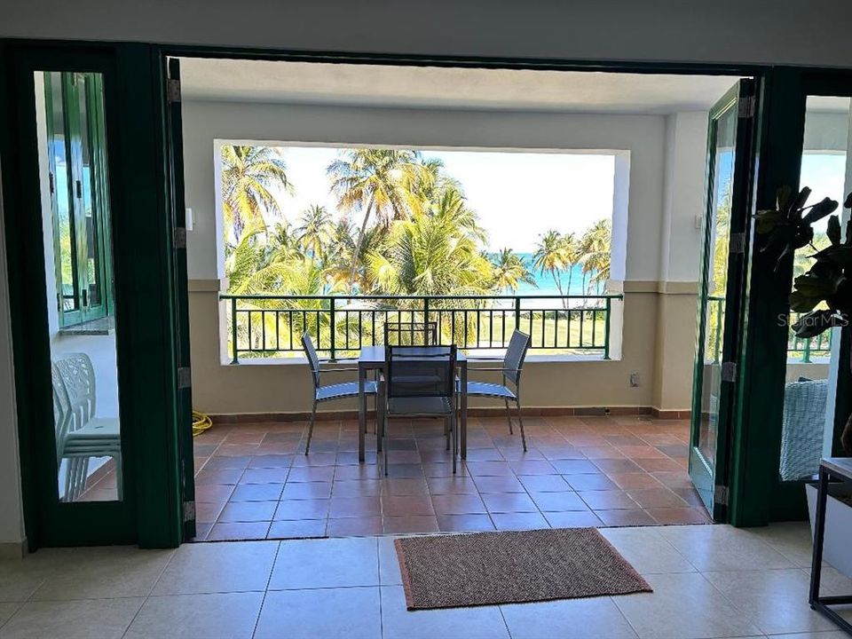 Living room access to large balcony.  Open folding doors for enjoyment of ocean breeze.