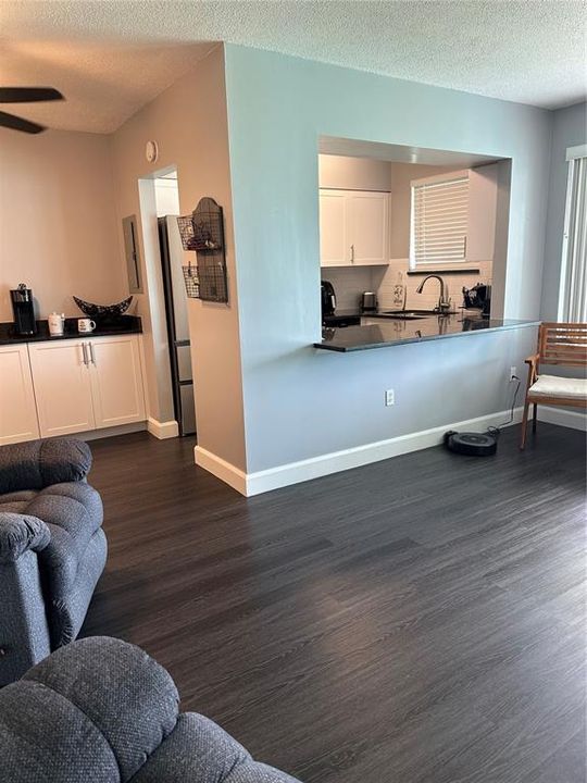 Living room with view of the kitchen.