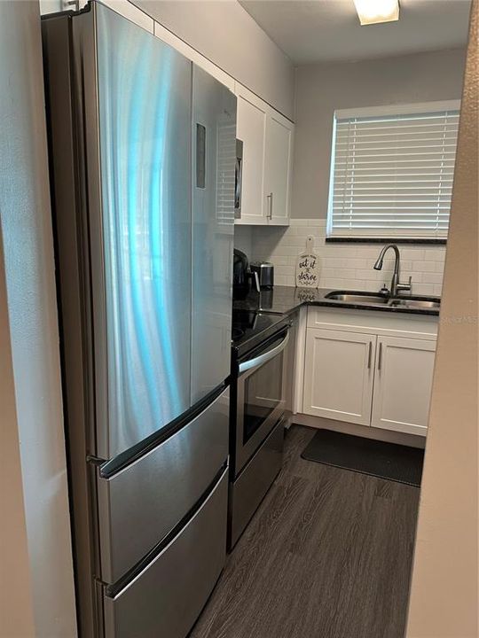 Kitchen area with newer appliances.