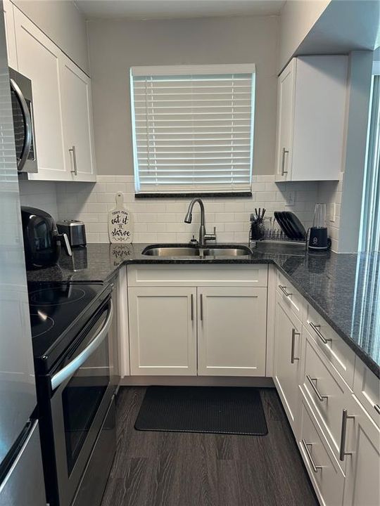 Kitchen area. Wood laminate flooring.