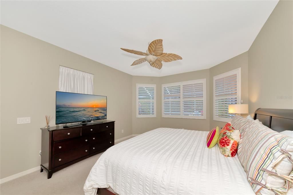 Primary suite with bay window overlooking pool spa & lanai.