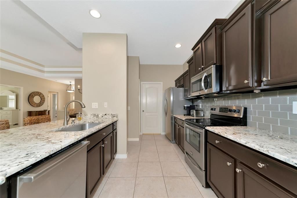 Stainless steel appliances, 3cm granite tops & designer backsplash