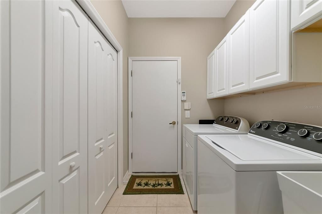 Laundry room w/ utility sink and pantry closets.