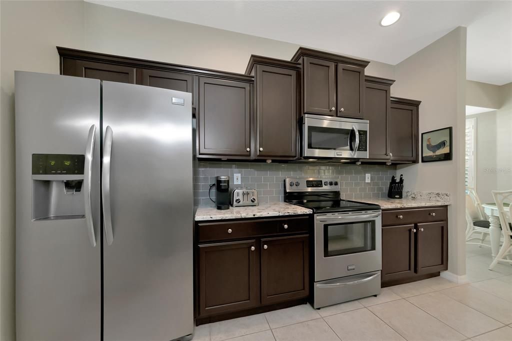 Stepped wood cabinets. Home is plumbed w/natural gas.