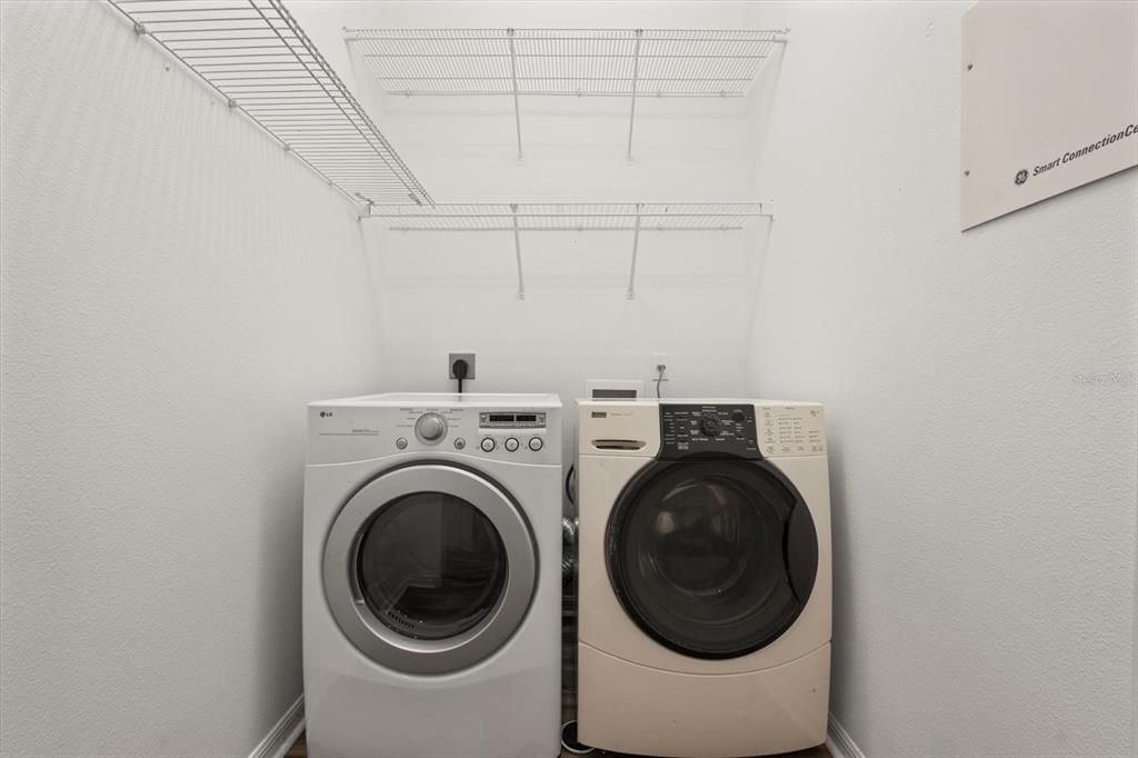 Laundry Room with High ceiling for cabinets or shelving