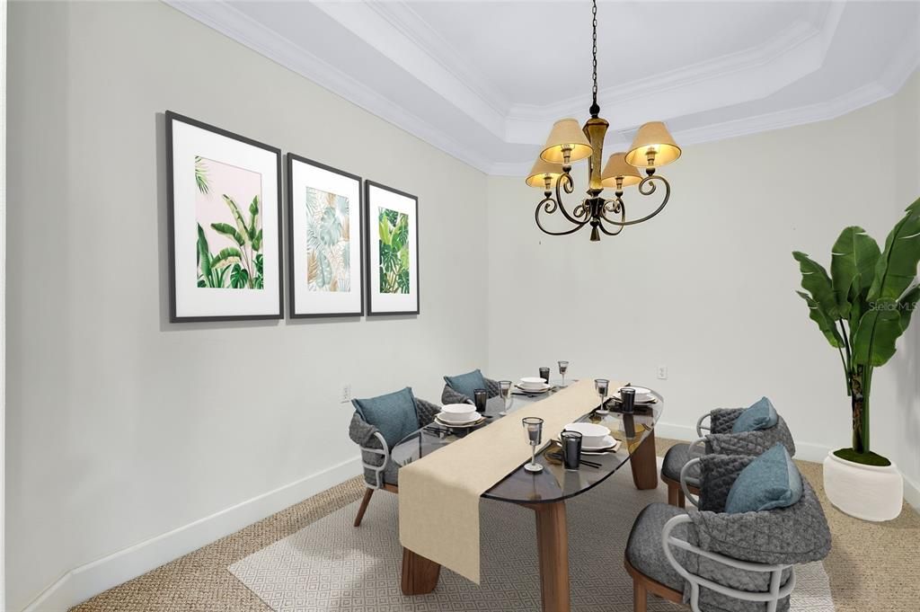 Dining Room featuring an inviting chandelier, carpet, a tray ceiling, and ornamental molding