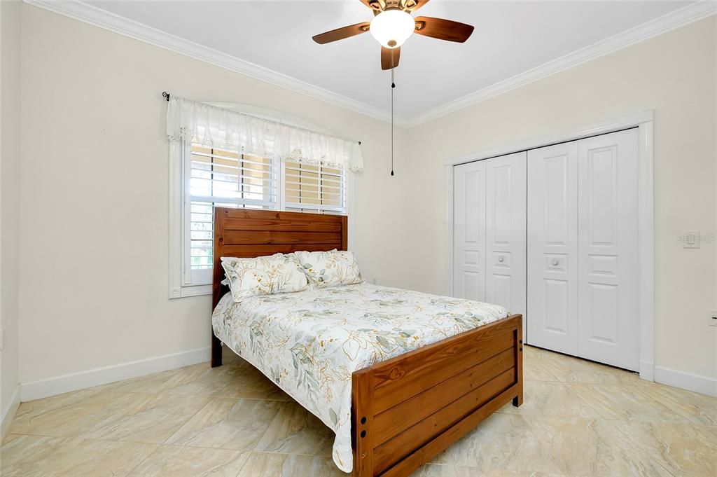 2nd Bedroom featuring crown molding, ceiling fan, and a closet