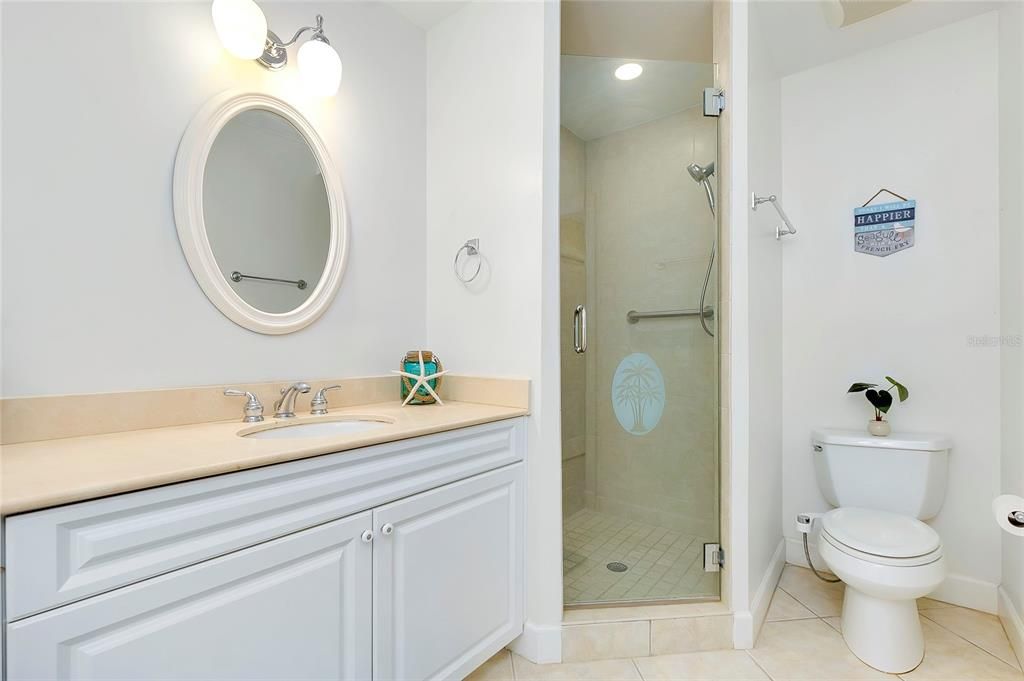 Main Bathroom with tile patterned flooring, vanity, and a shower with shower door