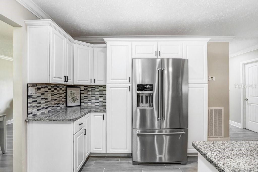 large refrigerator with side pantry cabinets