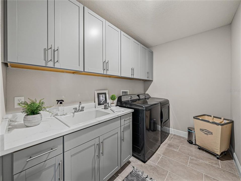 Huge Laundry Room Upstairs with Quartz Counters and Full Upper and Lower Cabinets with Hardware and Laundry Sink