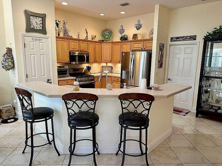 Open Kitchen featuring Vaulted Ceilings, Wood Cabinetry, New Stainless Appliances and Gas Range.