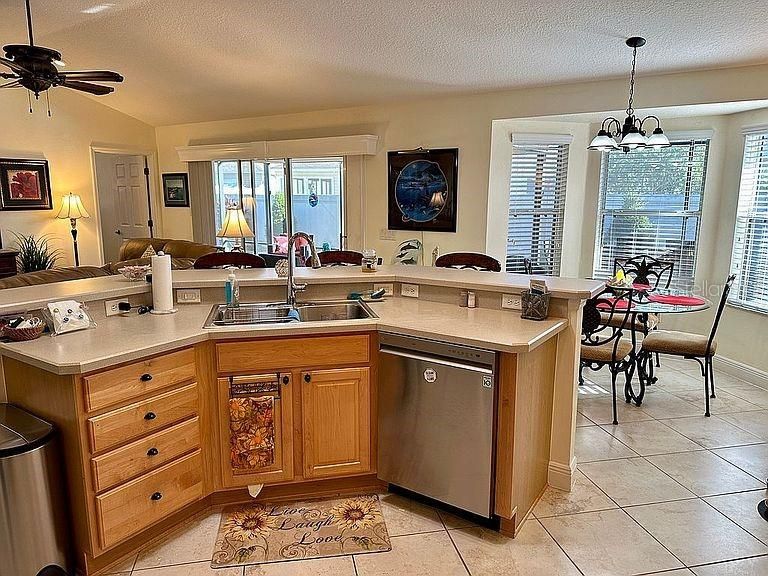 Open Kitchen featuring Vaulted Ceilings, Wood Cabinetry, New Stainless Appliances and Gas Range.