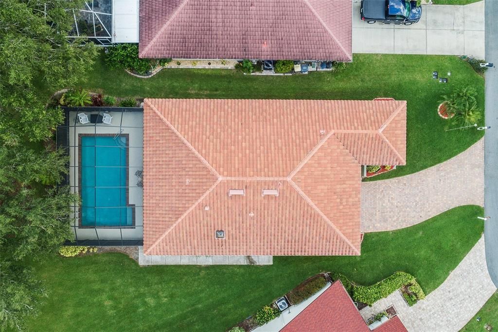 AERIAL VIEW OF GORGEOUS TILE ROOF  REPLACED IN 2021, POOL AREA AND DRIVEWAY