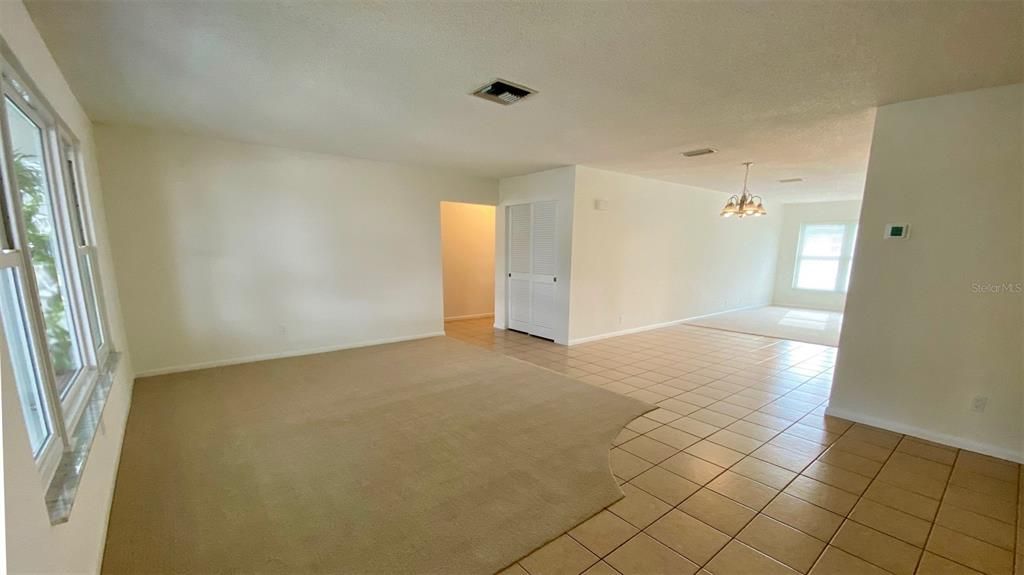 This living Room (carpet) and dining room (tile) offer plenty of room to entertain.