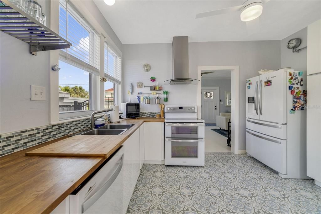 Enjoy the UPDATED KITCHEN, gorgeous white washed WOOD FLOORS, thoughtful accents that include SHIPLAP WALLS and CUSTOM TILE, and there is even a DETACHED GARAGE with tandem parking for two and space above ready to become an IN-LAW/GUEST SUITE for added investment potential!