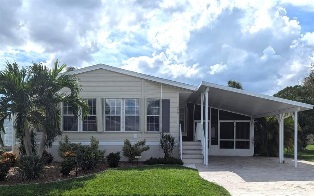 979 FRONT OF HOME WITH CUSTOM EASY TO USE HURRICANE SHUTTERS