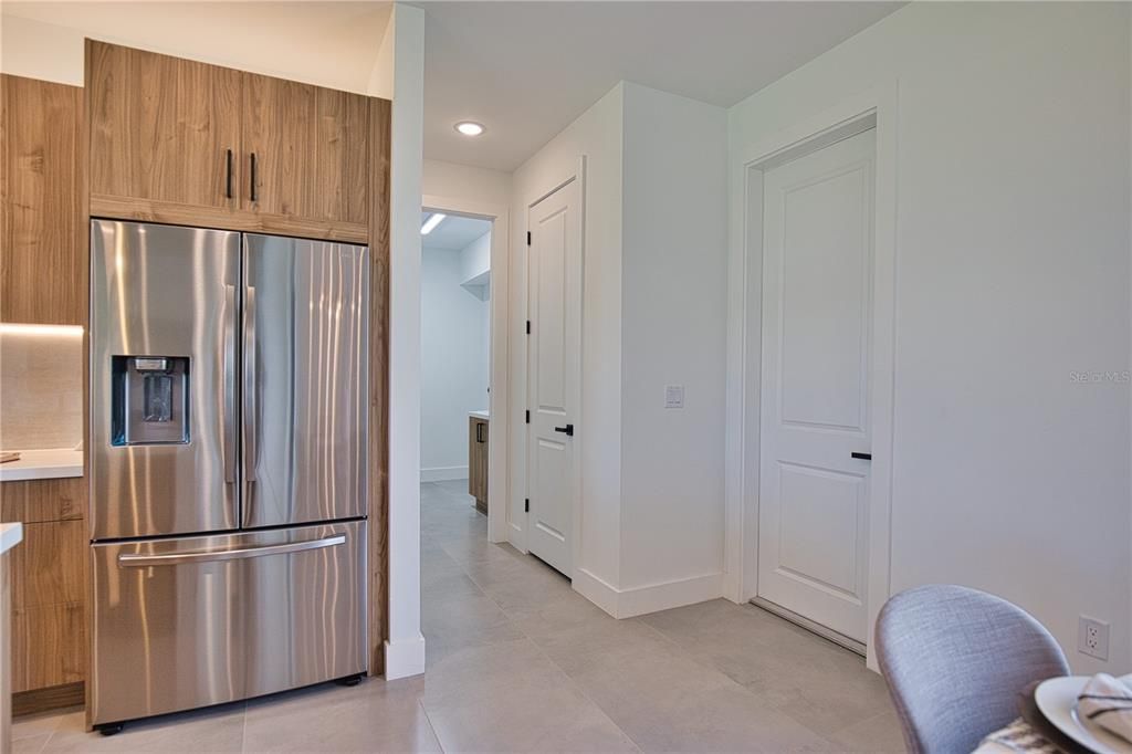 Door to garage on right and entrance to laundry room