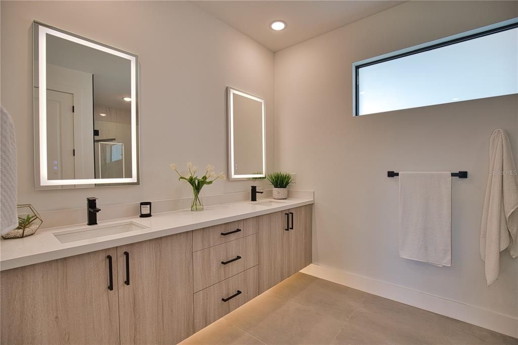 Spa Master en suite bathroom. LED lighting under vanity and on mirrors.