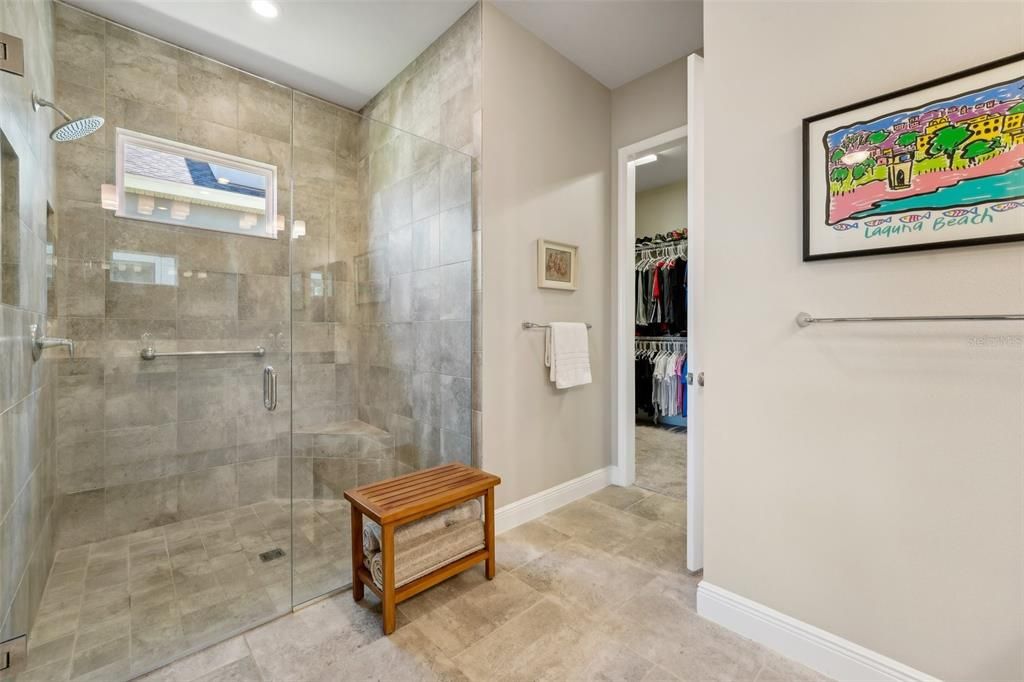 large walk in shower with tile to the 10' ceiling