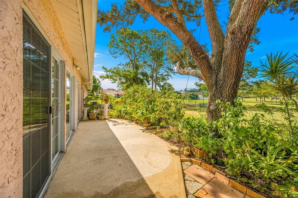 Outdoor patio perfect to watch golf or enjoy the lush landscaping and garden area.