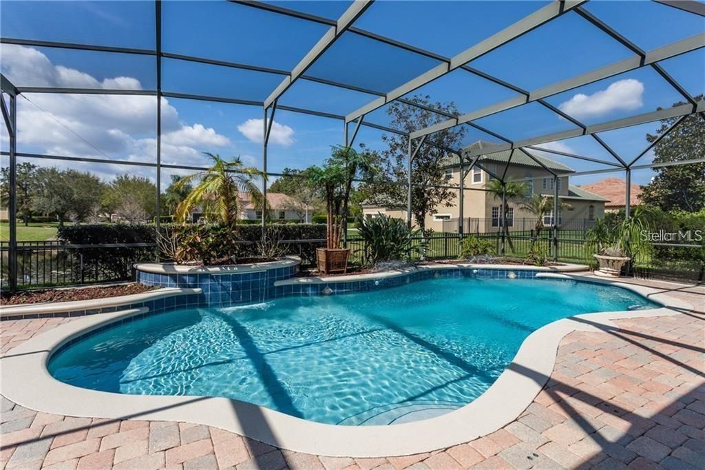 Pool overlooking the pond and fenced yard