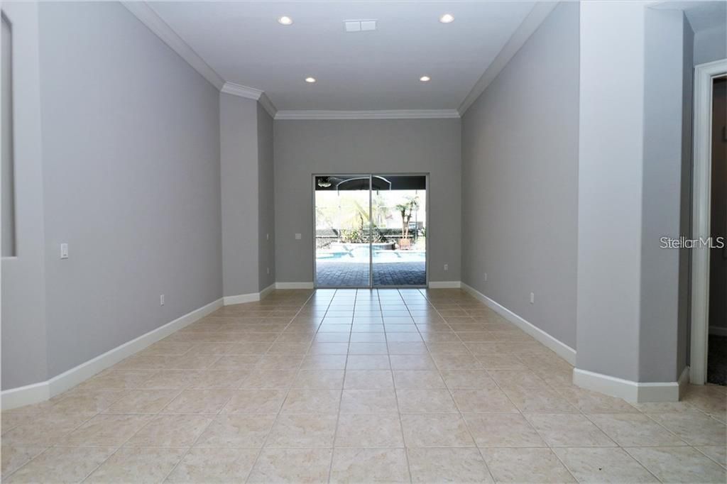 Formal living room overlooking lanai and pool.