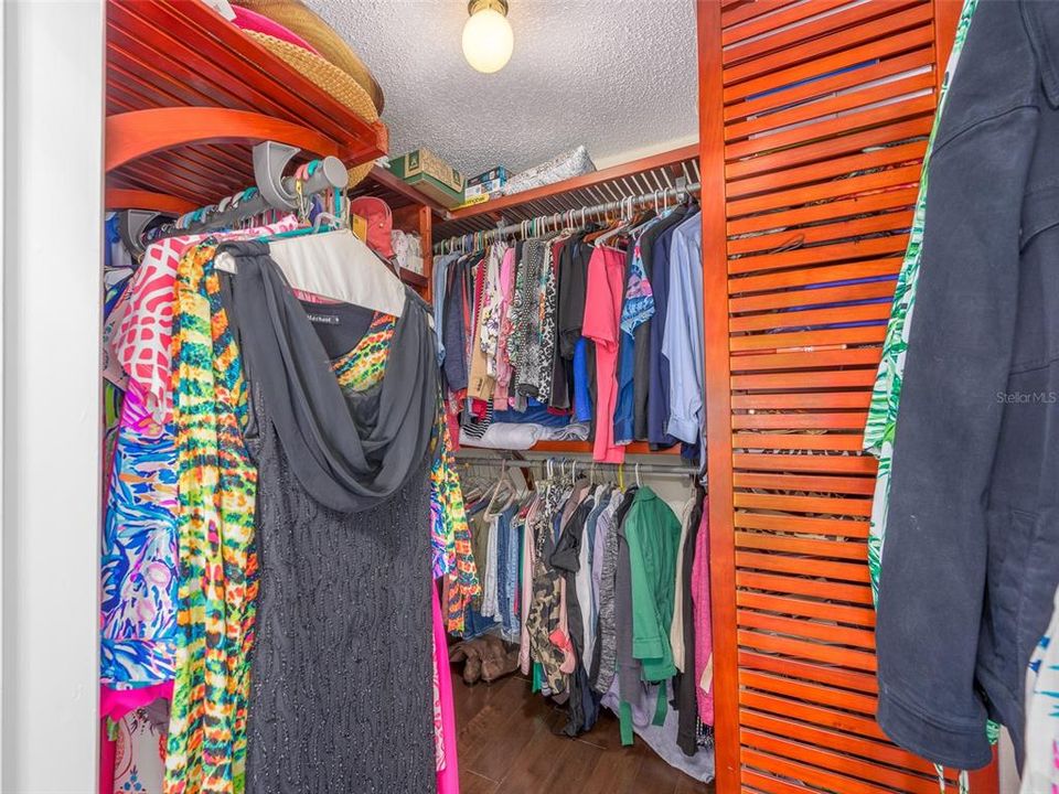 Spacious walk-in closet with ample shelving and hanging space, perfect for organizing clothing and accessories.