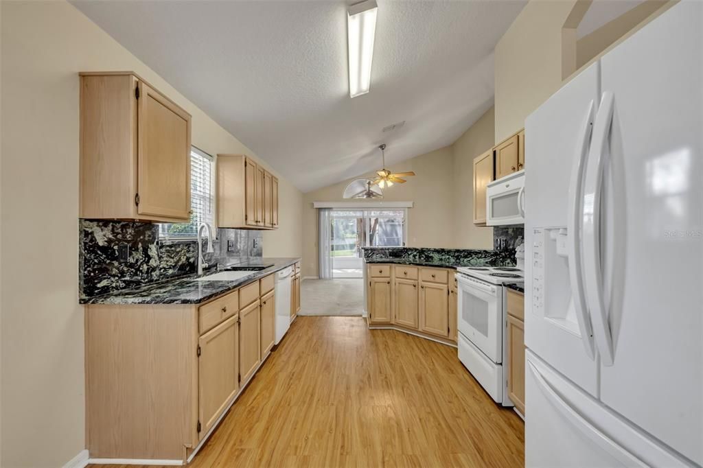 Kitchen view toward family room and screened porch