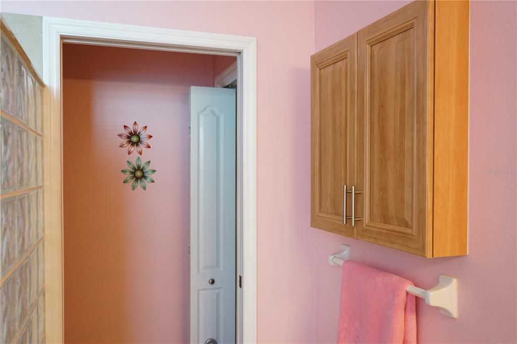 wall cabinets and toilet room has a linen closet