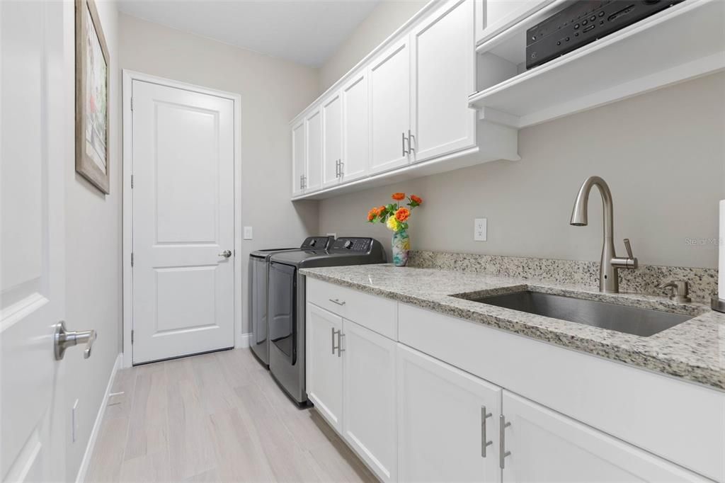 Laundry room with upper & lower cabinets and sink