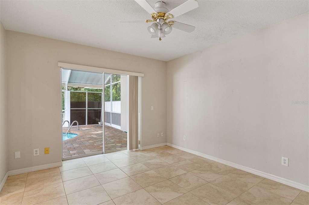 Bedroom #2 on split floor plan has sliders going to pool area