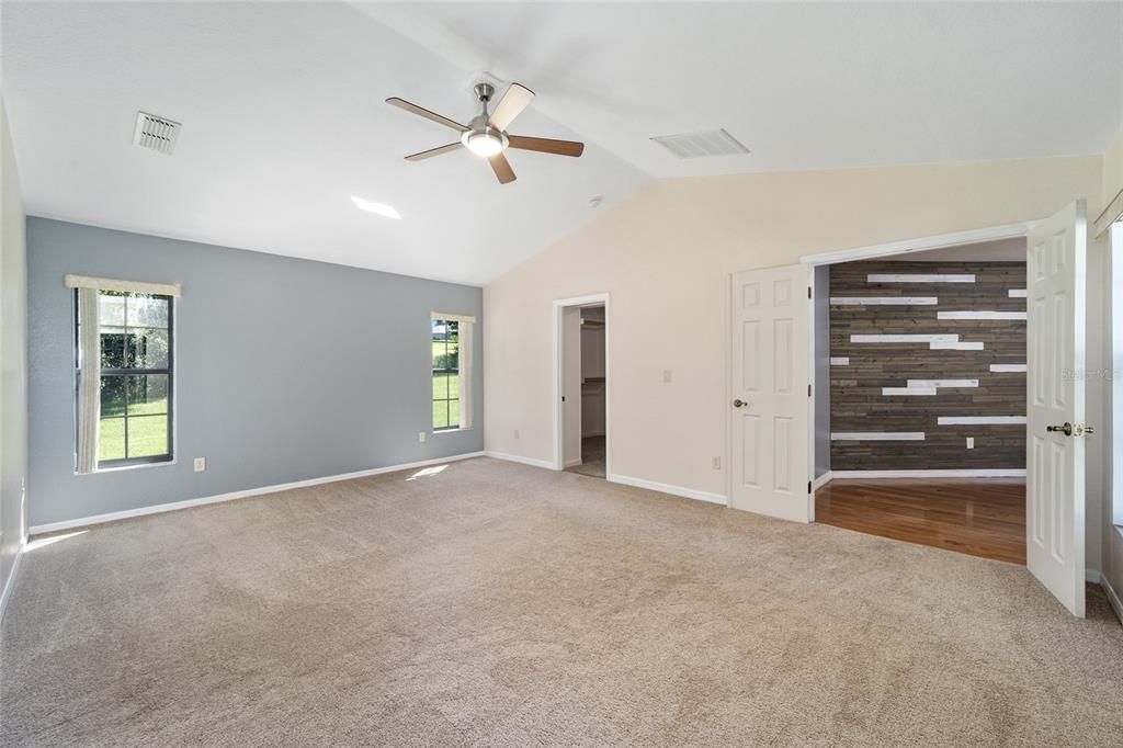 Primary bedroom with one walk in closet looking at hallway to office