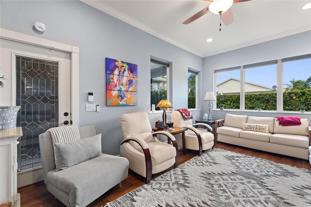 Comfortable living room with electric shades behind sofa