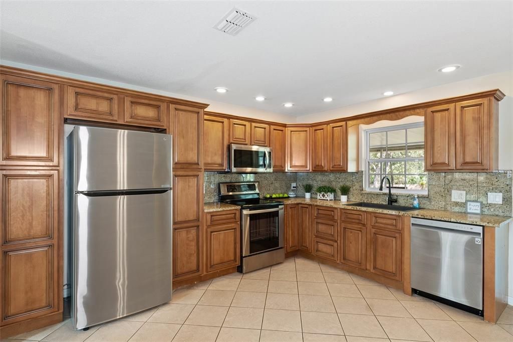 The kitchen has an abundance of gorgeous cabinets