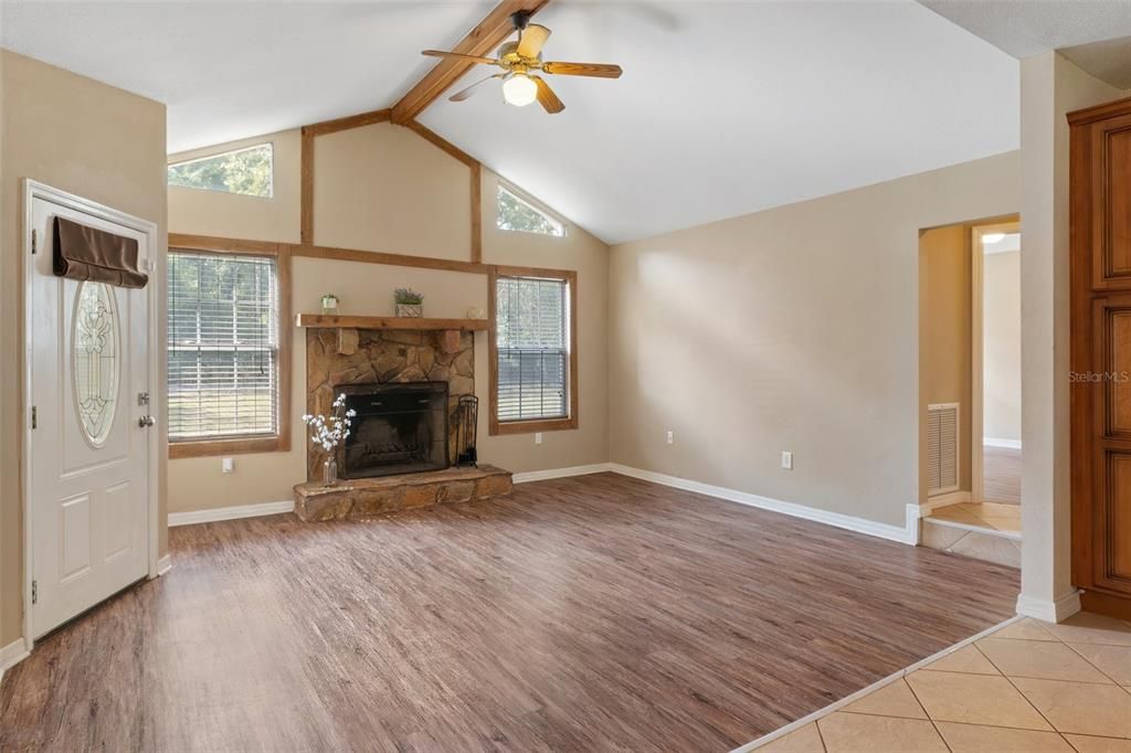 Notice the wood burning fireplace in the living room