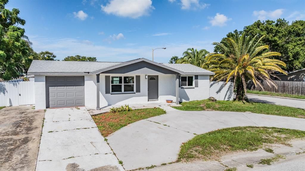 Front exterior with circular driveway, minutes from the water.