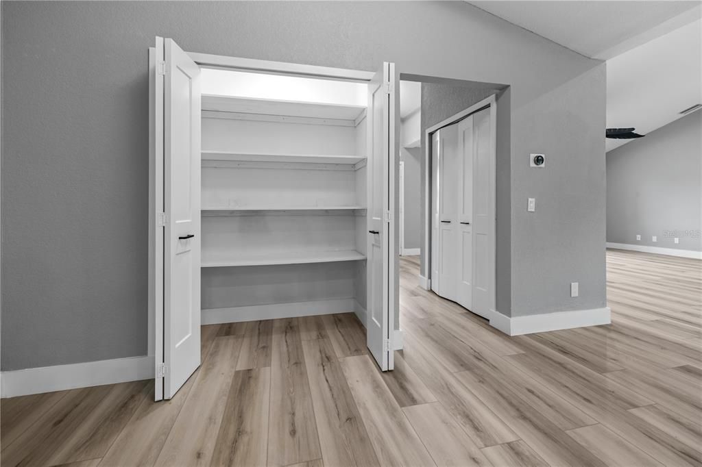 Double door closet pantry with an automatic light that turns on with a motion sensor!