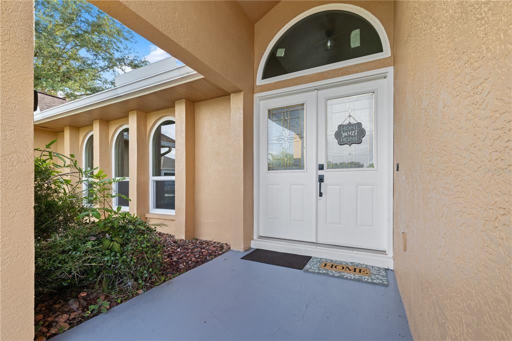 Grand double door entrance with a lovely transom and tall entry