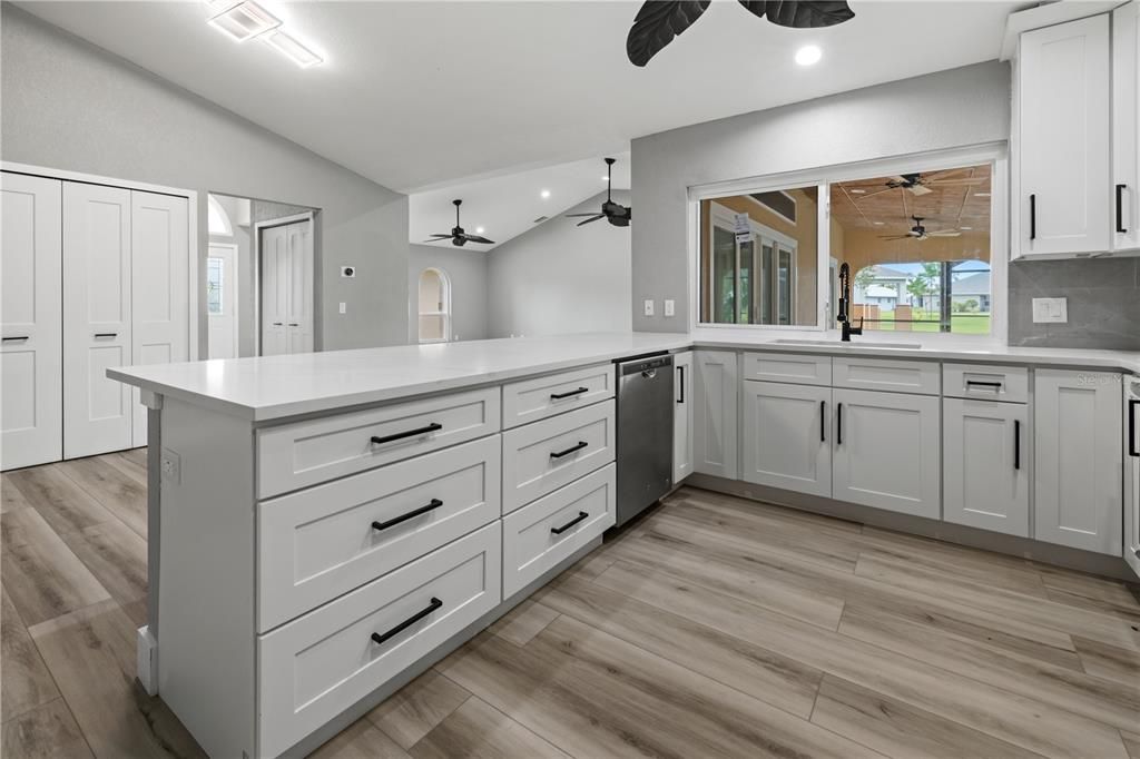 Chef's dream all wrapped up in this kitchen! Solid stone granite counters, white shaker cabinets with black hardware, double door closet pantry and stainless appliances