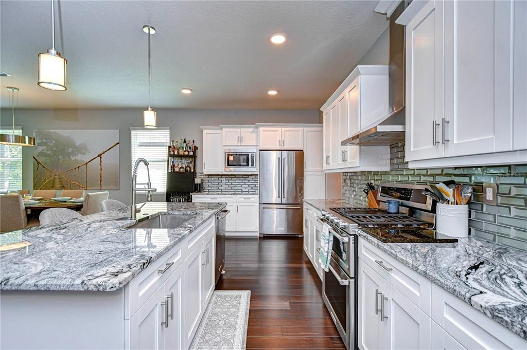 Marvelous kitchen will be one of your favorite spaces to entertain featuring granite counters and tile back splash!