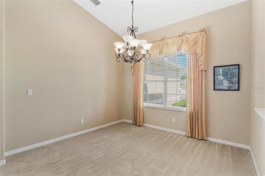 Dining Area with an Elegant Chandelier and Double Pane Windows