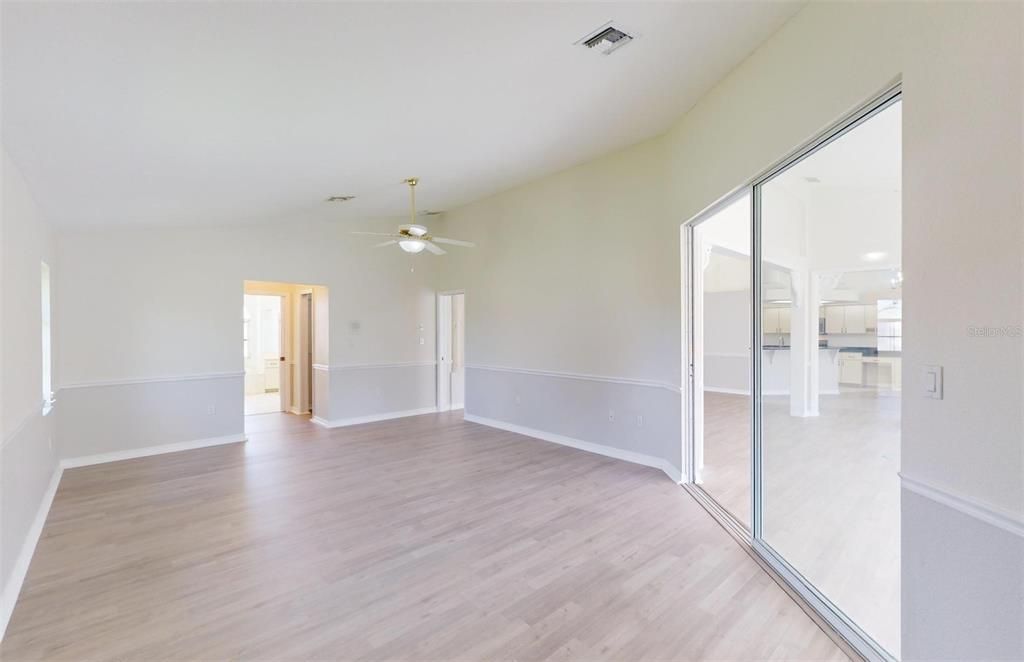 Looking from the Primary Bedroom sliders onto the Great Room/Sunroom