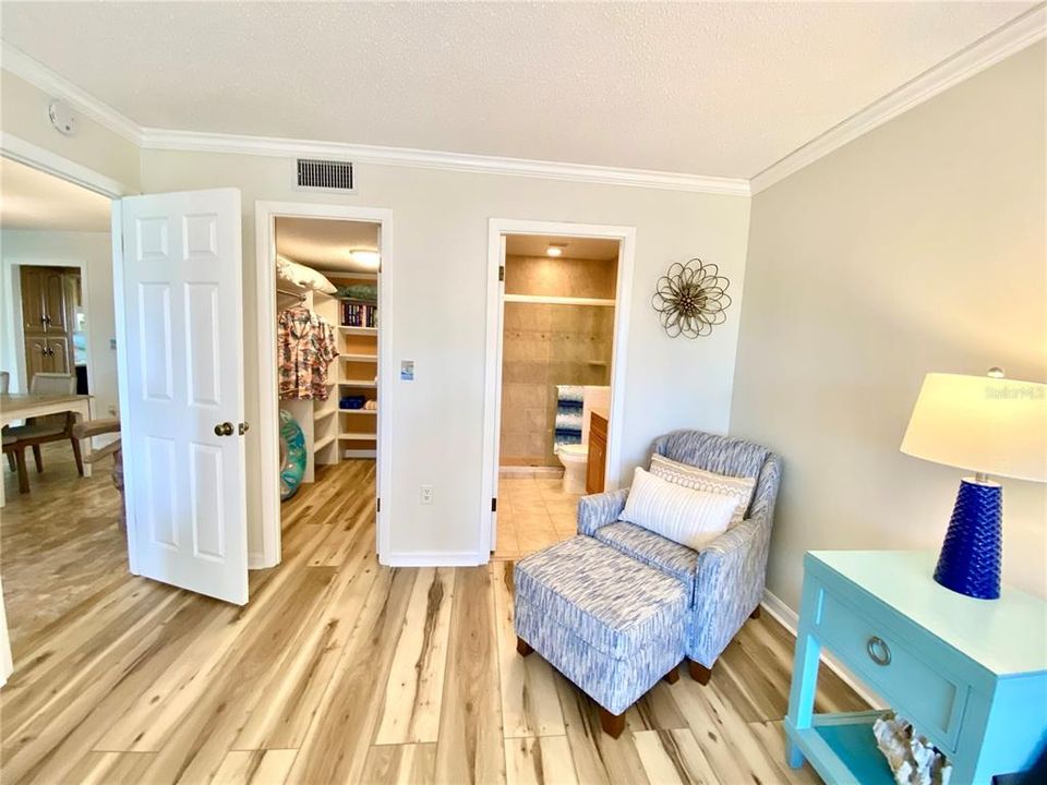 Walk-in closet and en-suite bathroom from primary bedroom