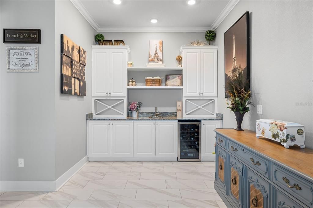 Kitchenette, Cabinet & Shelving Storage with Granite Countertops, Stainless Sink, Wine Refrigerator, Crown Molding, Tile Flooring & Recessed Lighting too!